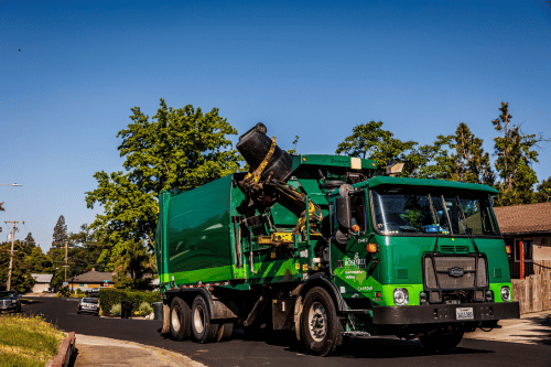 Residential garbage truck picking up a cart